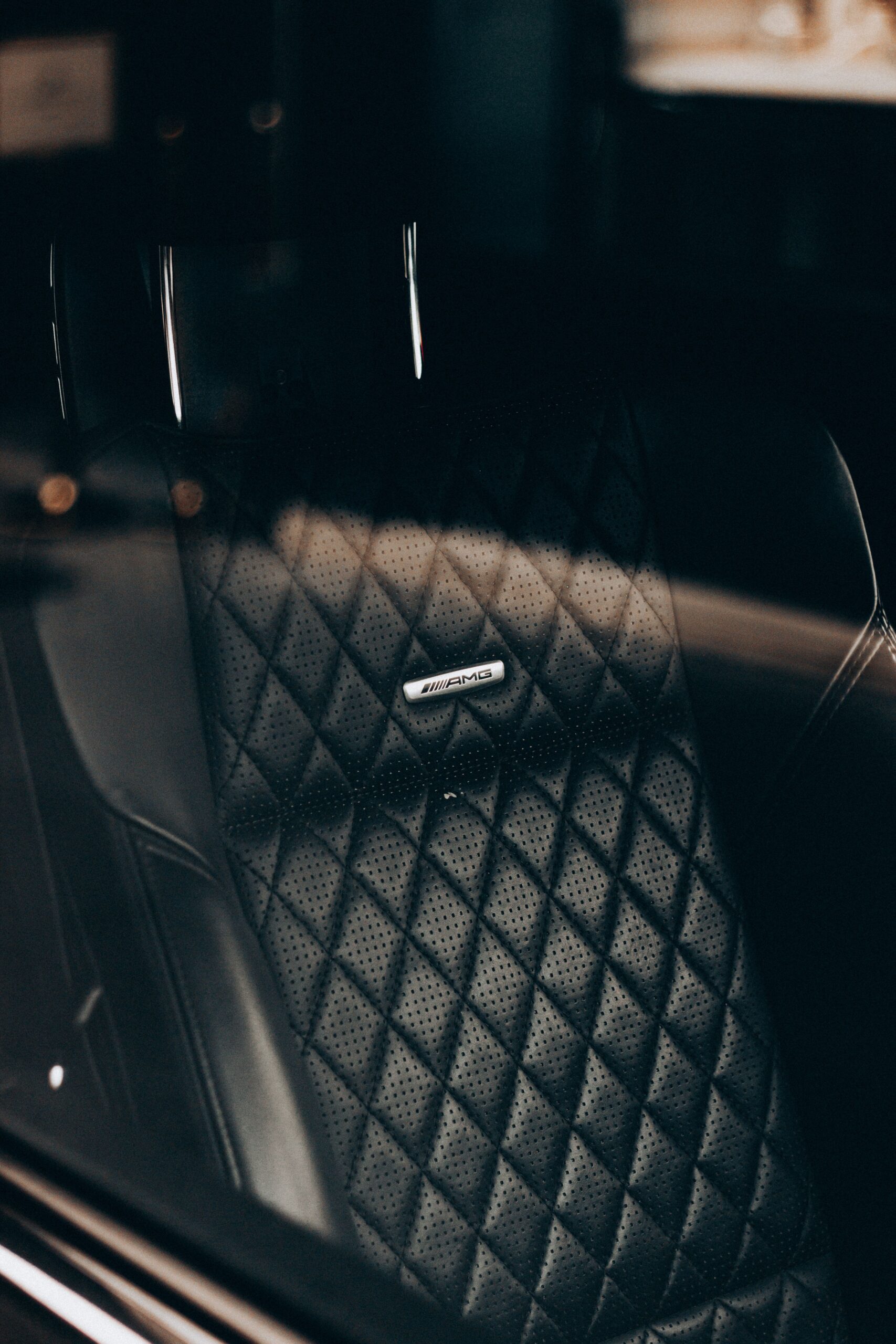 our-services-02 Through glass of expensive car black leather front seat in rays of sunlight
